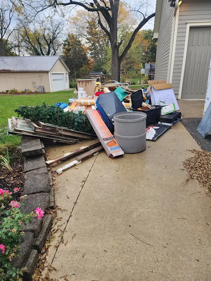 Dumpster being loaded with debris for Roofing Dumpster Rental in Escanaba